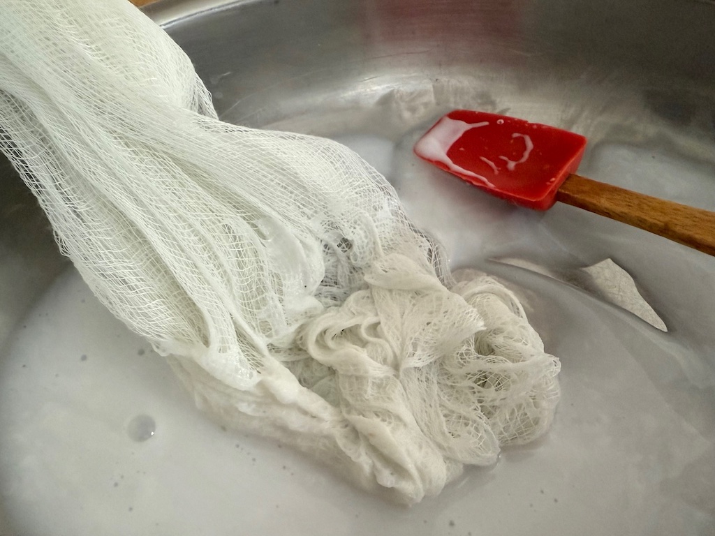 The cheesecloth, folded in half crosswise, is dipped into mixture of equal parts glue and water, up to 12 inches from the fold.