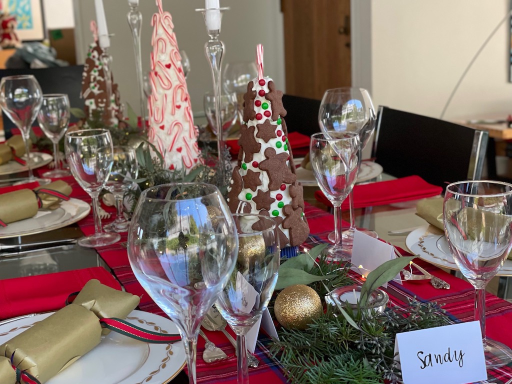 Table setting with cookie Christmas tree centerpiece.