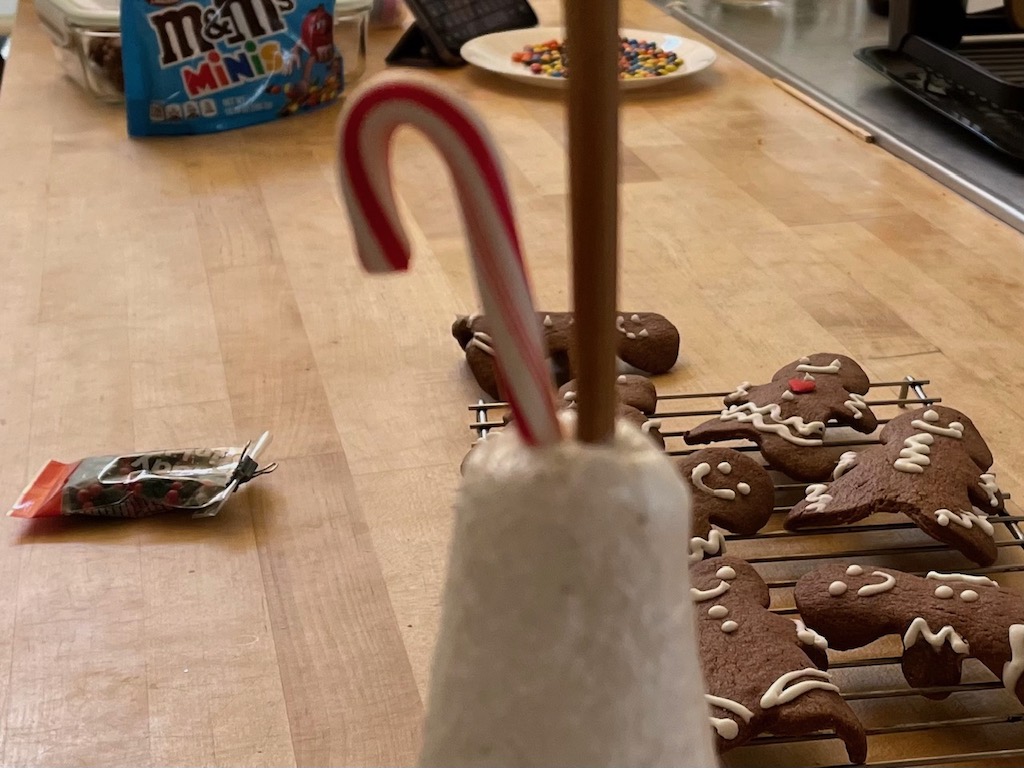 Chopstick is used to make a hole at the top of the Styrofoam cone; candy cane is inserted in the hole.