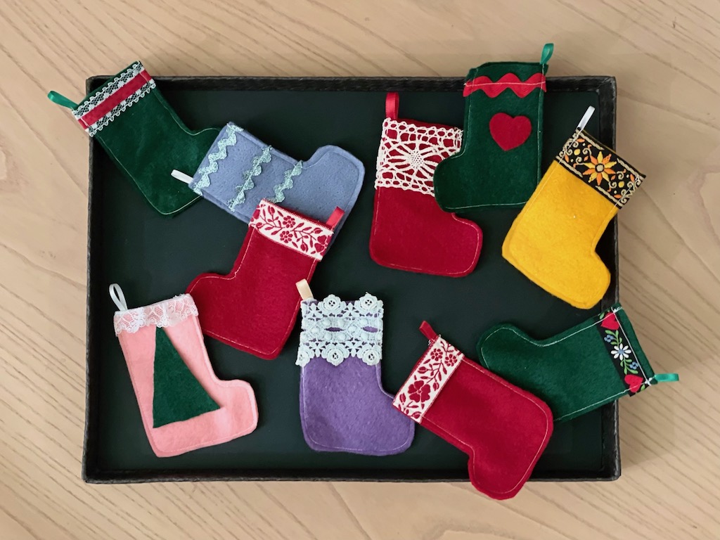 This Christmas craft idea is easy to make using felt and trimming scraps. Pictured is a sampling of tiny stockings.