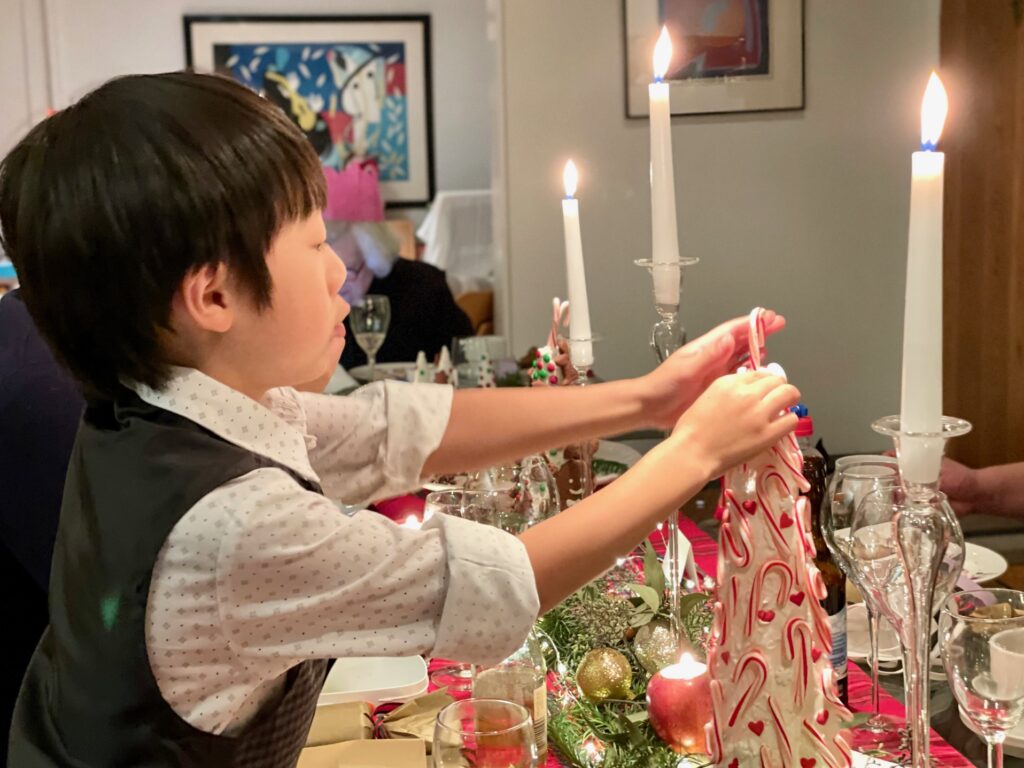 Child ready to devour the candy canes on the Christmas centerpiece.