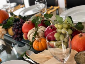 Fall produced are grouped along the dinner table to make an easy Thanksgiving centerpiece.