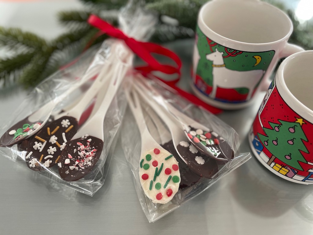 Package Hot Cocoa Stirring Spoons in cellophane bags, tie with ribbon, and accompany with a Christmas mug.