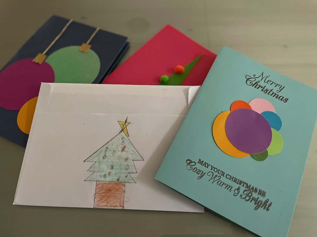 Christmas cards made with cardstock, colored paper, and word stamps.