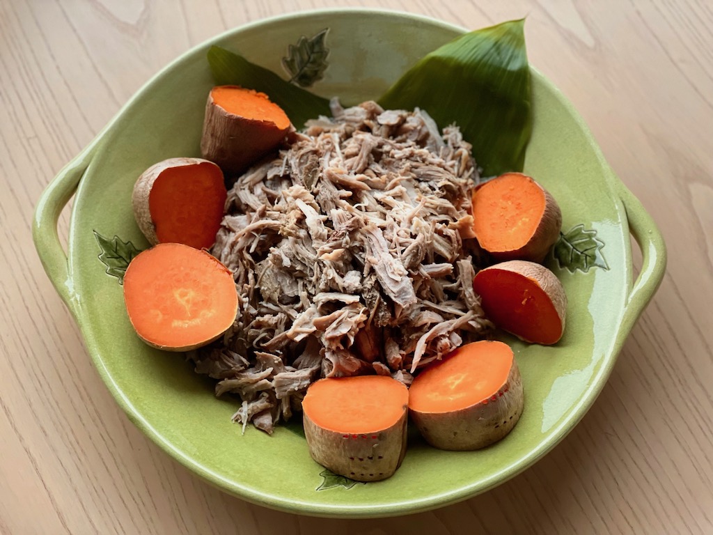 The main course for this luau party is kalua pig, roasted in the oven instead of in an outdoor pit, and baked sweet potatoes.