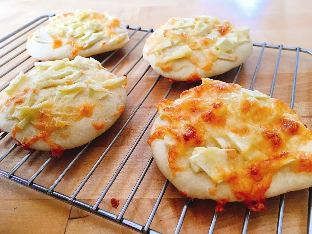 Apple and Cheddar pizzas made as a snack by a three-year-old.