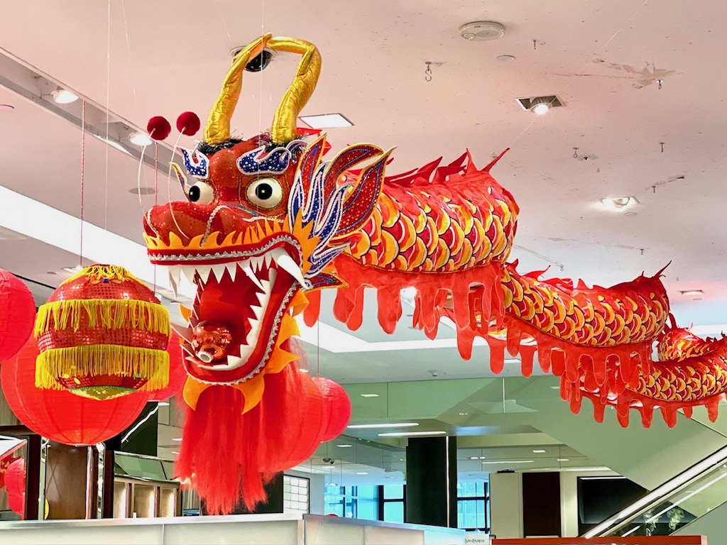 A life-size dragon hangs at Bloomingdale's department store.