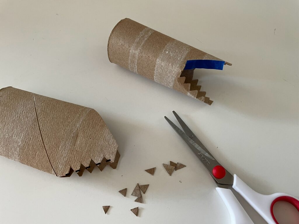 A close-up to show how to cut the dragon's teeth, fold it into the mouth, then cover the teeth with blue painter's tape to protect the teeth from errant paint strokes.