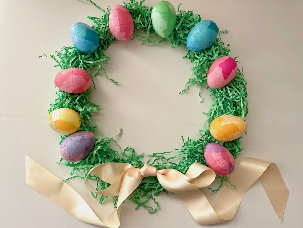 Cover wire wreath frame in Easter grass, then decorate the wreath with tissue-paper-covered plastic Easter eggs.
