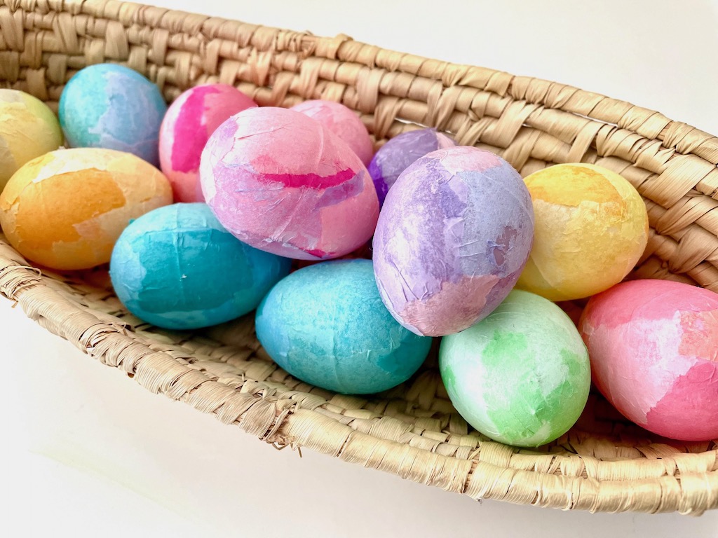 Tissue-paper-covered eggs, arranged in a basket, make a pretty centerpiee.