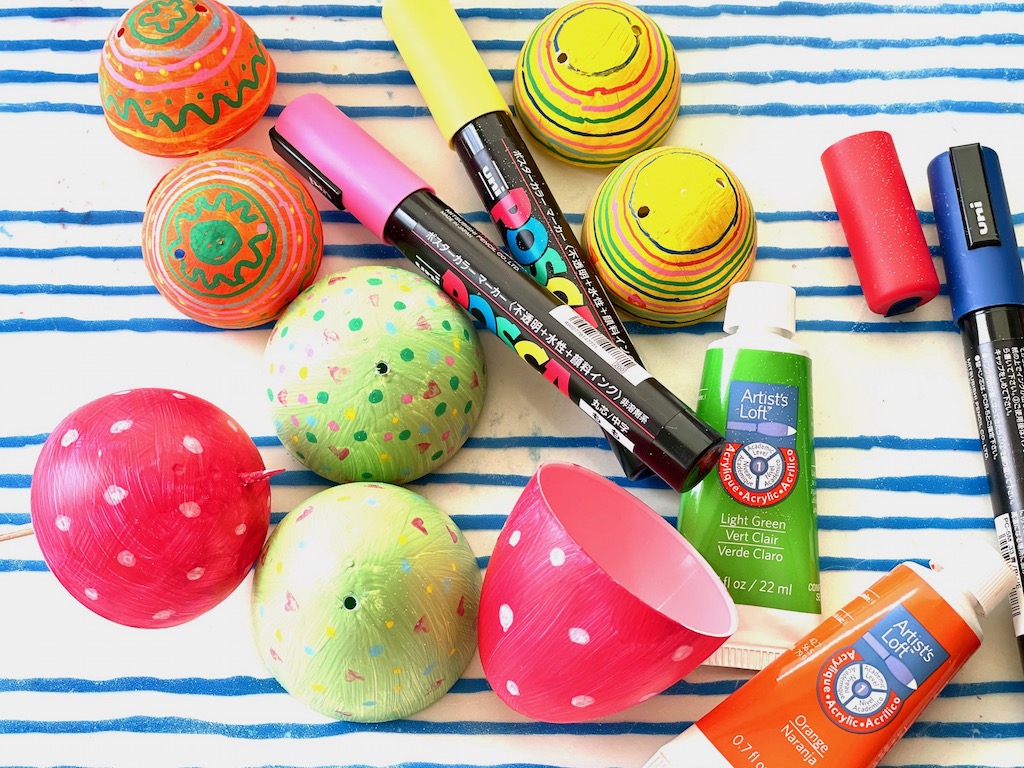 To begin this plastic egg Easter craft project, pain the egg with acrylic paint, then decorate with markers.