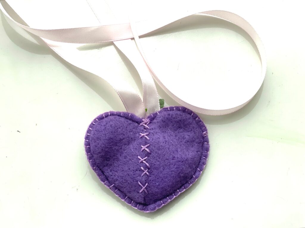 Put the AirTag into the heart and stitch the back closed with cross stitches.