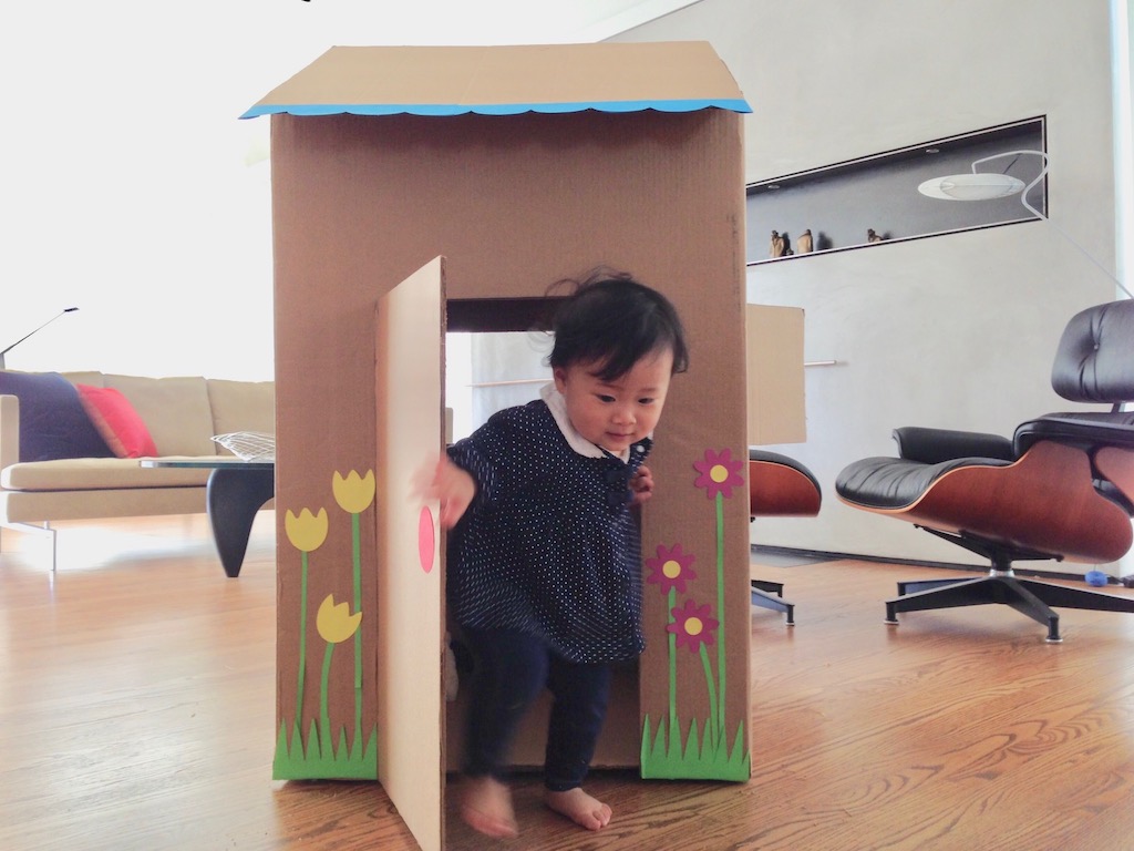 Instead of throwing away a large box, turn it into a house for a toddler.