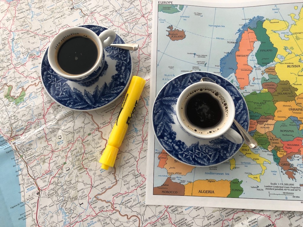 Armchair trip planning with coffee and maps.
