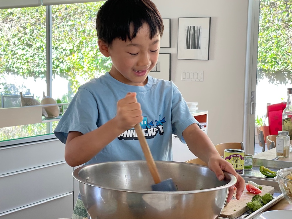 Child mixes ingredients in a big bowl; the large size keeps ingredients from spilling out.