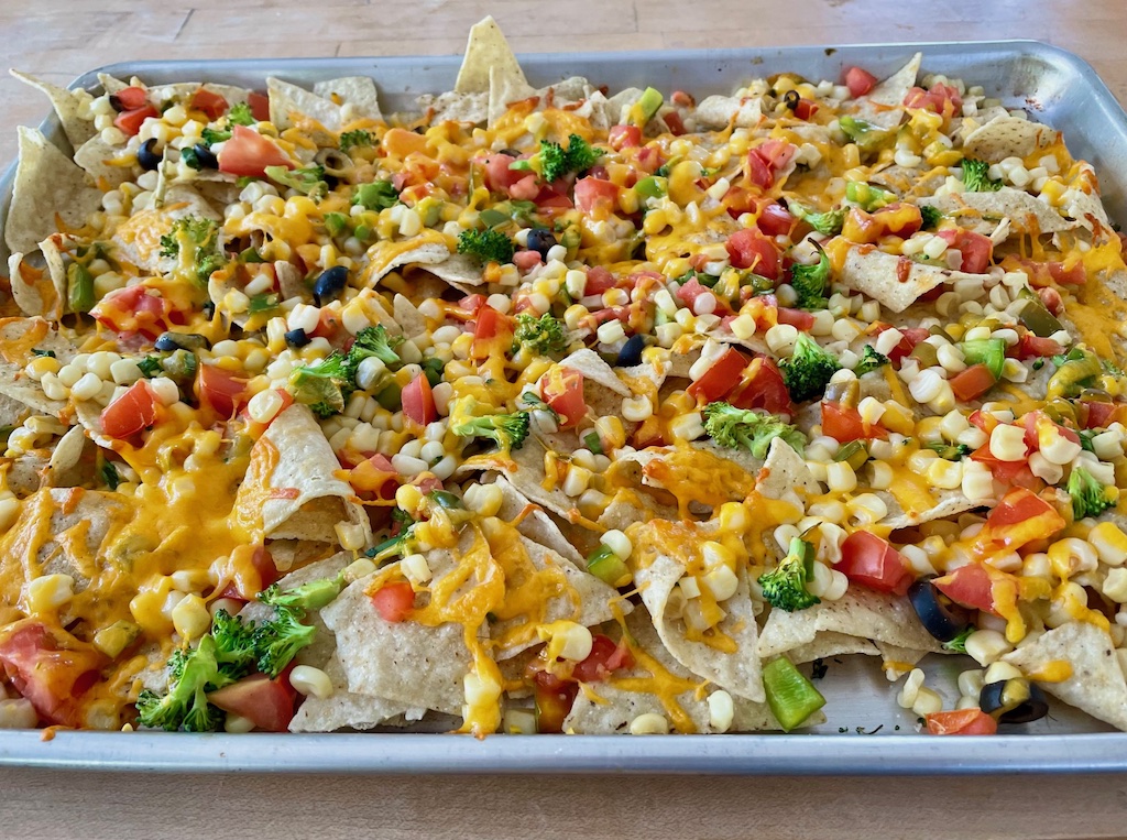 A sheet pan of colorful, Healthy Vegetable Nachos made by a seven-year-old child. 