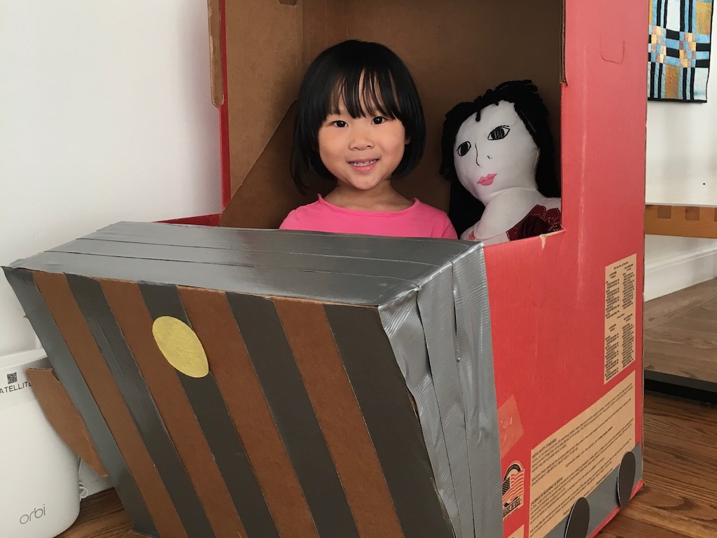This train engine is a child's car seat box, transformed with electrical tape and a few cardstock cutouts.
