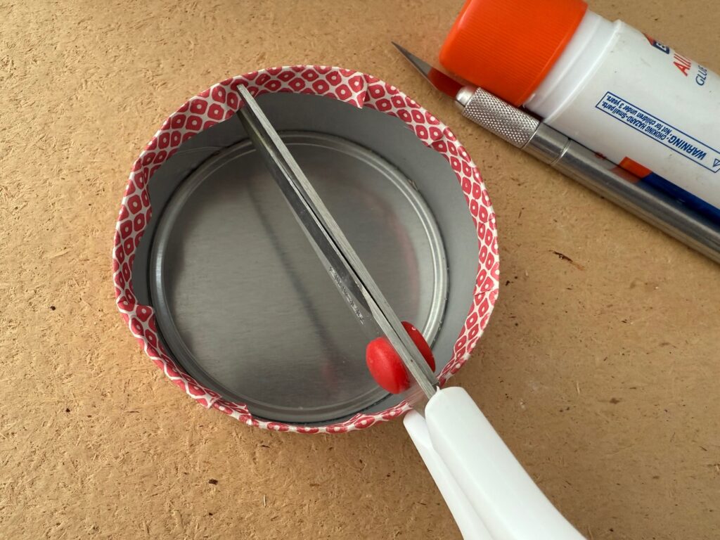 If the overhang ripples, snip in a few places with scissors, add glue, and smooth down.