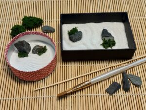 Two finished mini zen gardens, tools, and materials to make a Father's Day gift.