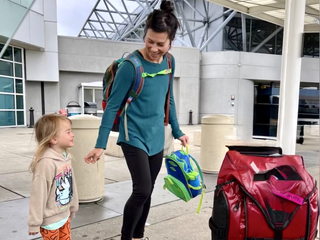 Mother and child at the airport after visiting long-distance grandparents.