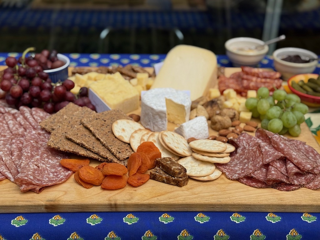 A charcuterie board features cheeses,cured meats, crackers, and dried fruits and nuts. It's the ultimate in easy party food.