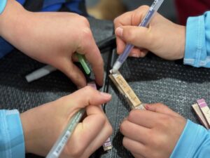 Clips are wooden clothespins decorated with affirming messages by girls on volleyball teams who give them randomly to other players.