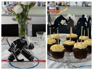 ice hockey-themed party features cut-out goalie and hockey players on picks in cupcakes.