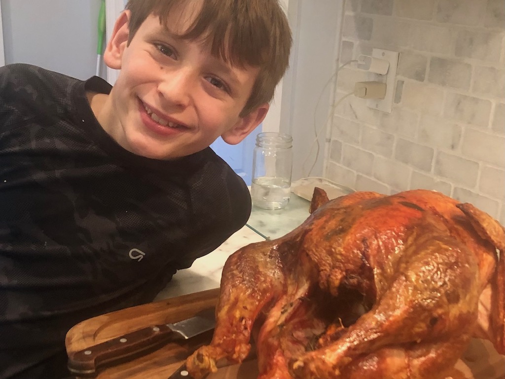 Sharon's youngest grandson is photographed with the holiday turkey. Next year, he will learn to carve it.