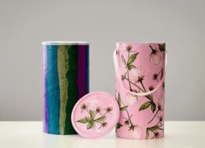 Turn oatmeal conainers into attractive storage boxes using tissue paper, or paint and printed cardstock.