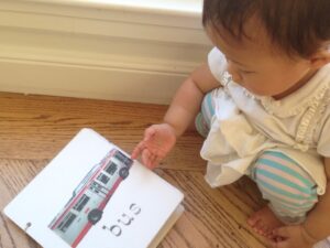 Toddler "reads" custom board book made by grandma.