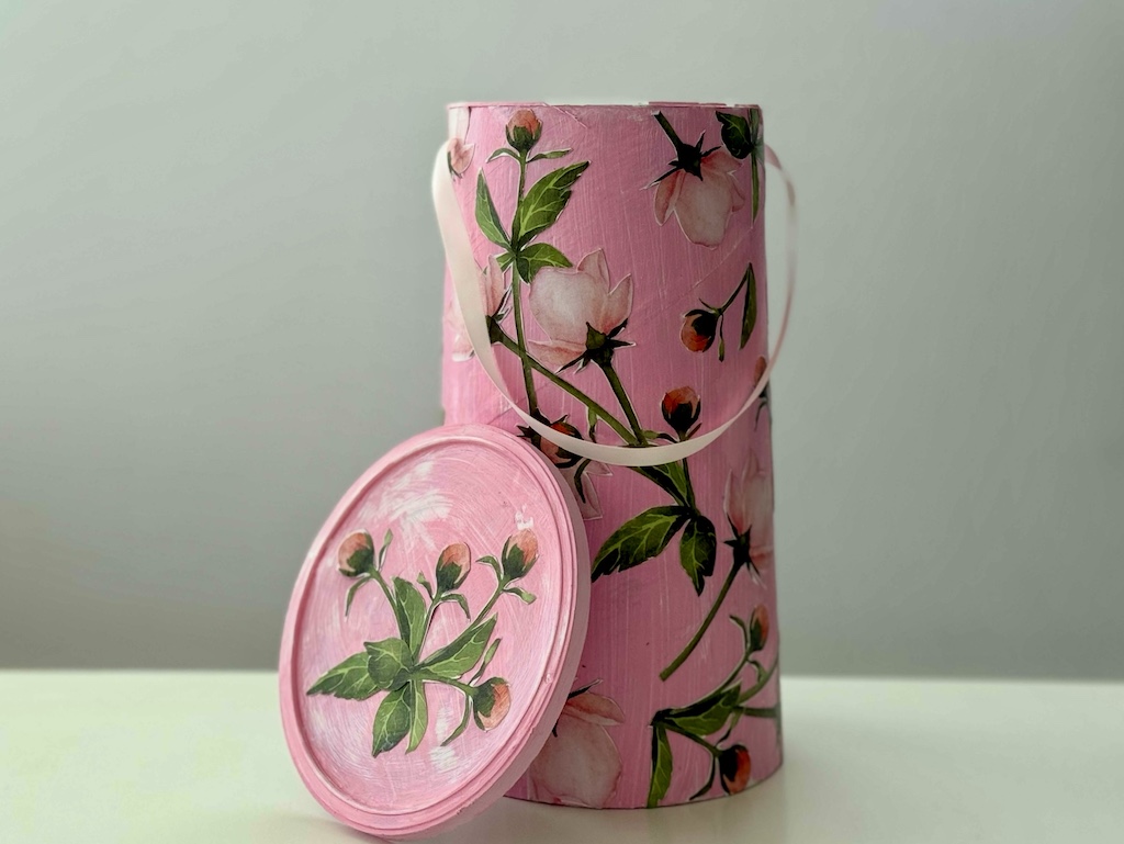 Recycle crafts using oatmeal containers: An example of a cut-out design: oatmeal container was painted pink and flowers were cut out from printed cardstock and glued on.