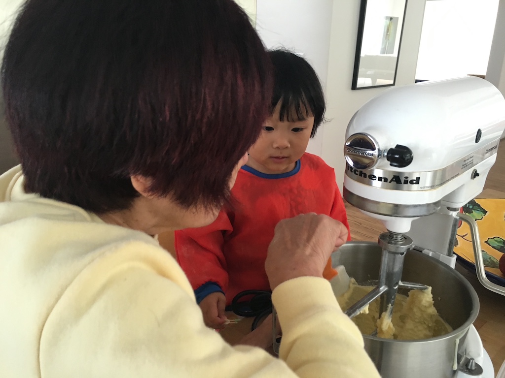 Grandmother and grandchild baking together. This is a good time to tell family stories about food.