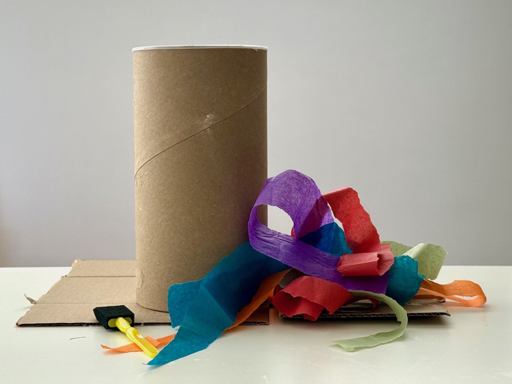 Throwaway oatmeal container and tissue paper scraps are used to make a storage container: a perfect example of recycle crafts.