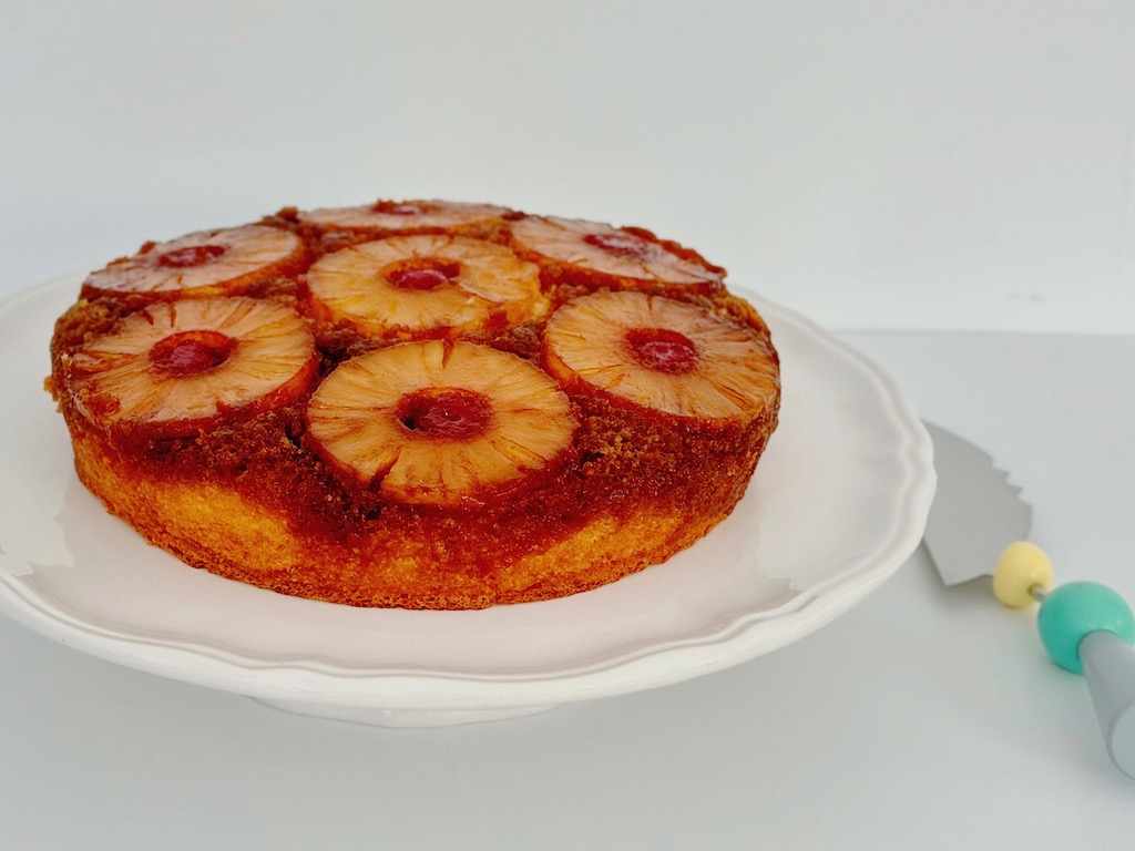 Pineapple upside-down cake is covered with pineapple slices and studded with cherries. Yellow cake mix is the cake base.