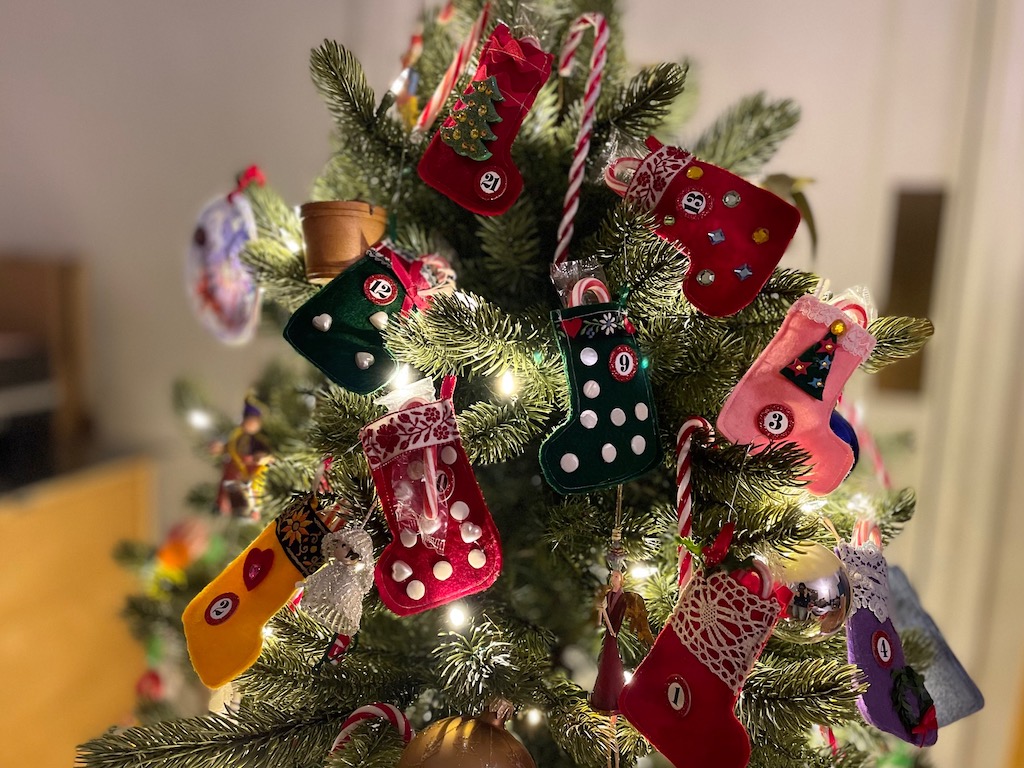 Twenty-four little stockings are decorated and numbered, and hung on a small Christmas tree to serve as an advent calendar. These stockings take time to make; prep months ahead.