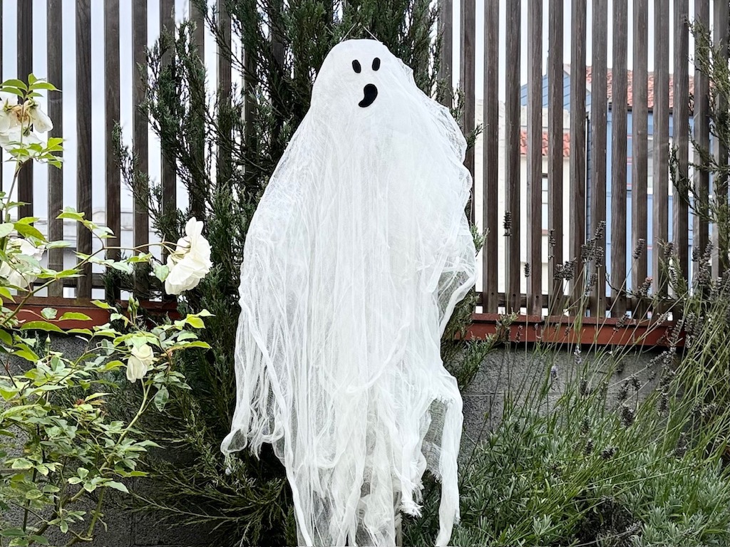 Almost life-size cheesecloth ghost hangs from a tree in the yard. Take it indoors at night or when it rains because only a bit of glue holds the ghost together.