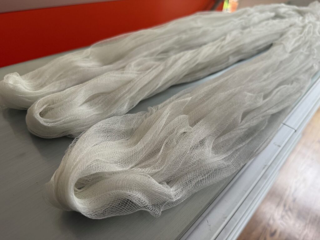 Three lengths of cheesecloth are cut for the cheesecloth ghost.