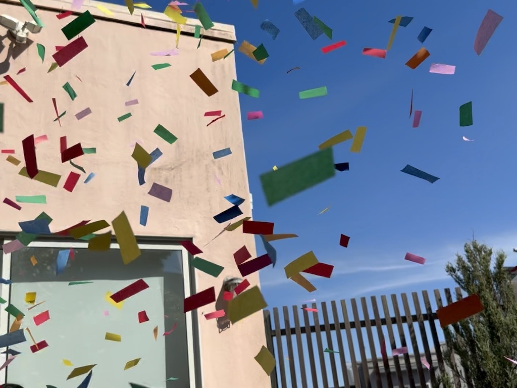 Colorful confetti fills the air.