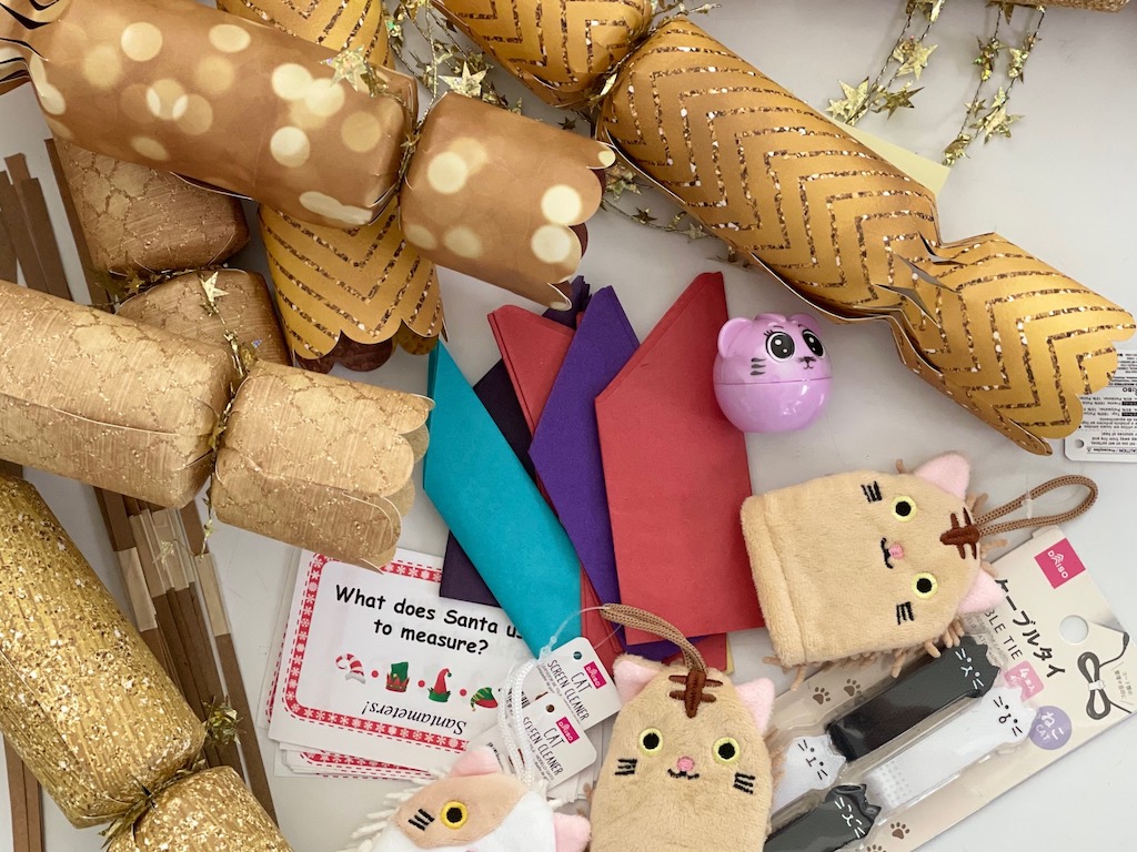 Christmas cracker can be made in advance. Each cracker includes a tissue paper crown, a joke or riddle, and a small treat.