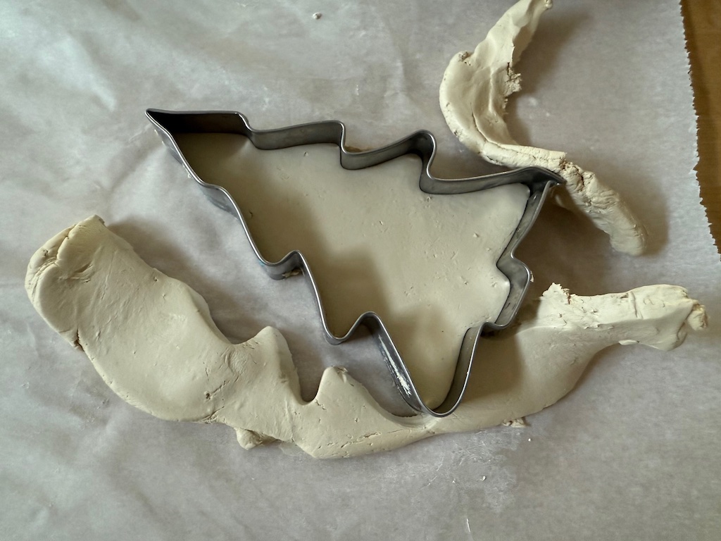 To remove cut cookies from the air dry clay dough, peel away the margins rather than trying to lift the cut cookie from the dough.