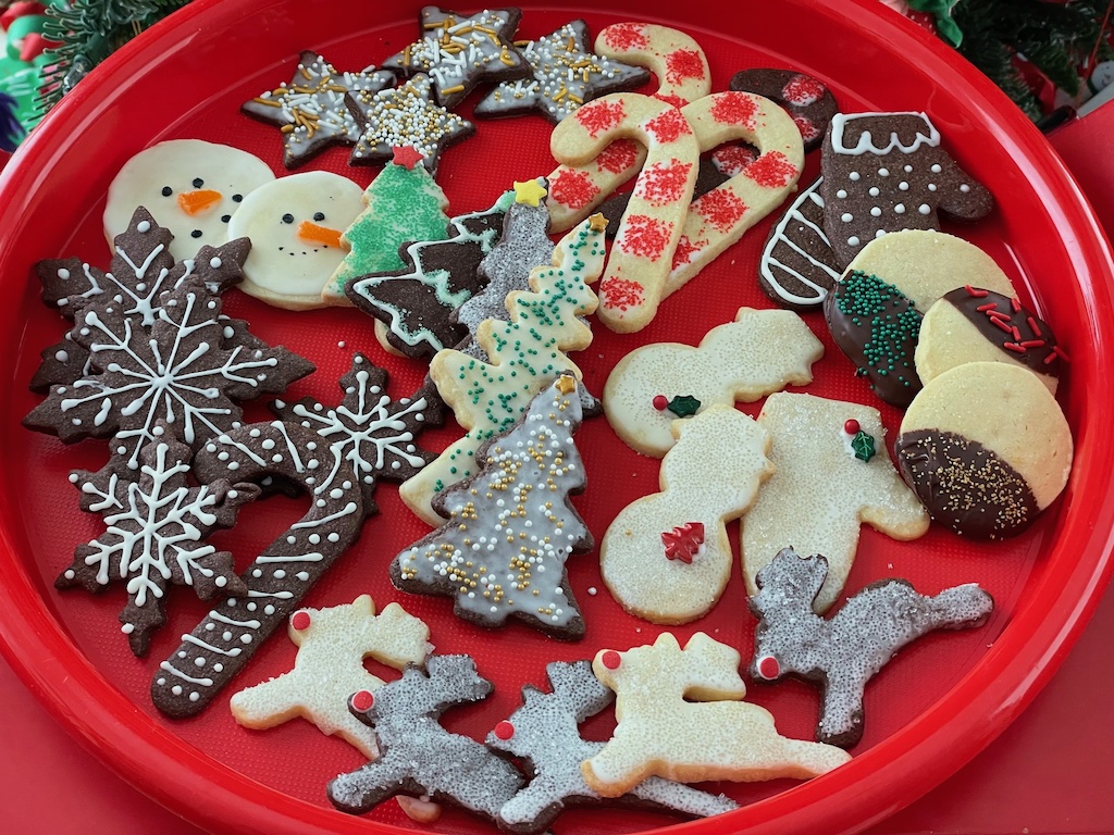 Cookies decorated for Christmas by grandma and grandchild.