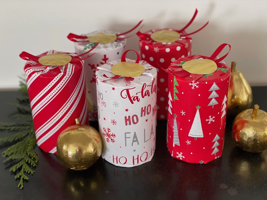 Cookies in recycled tins are wrapped for gift giving.