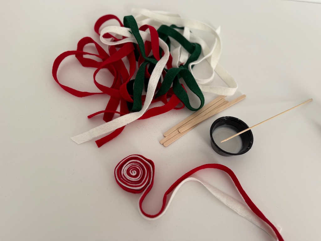 Two felt strips are nested together, then rolled to form a circle.