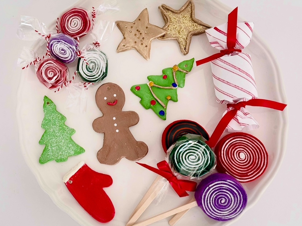 An assortment of cookies and candy made with air dry clay and felt.