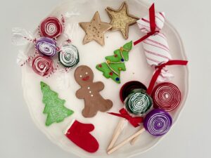 Candy and cookie Christmas tree ornaments are made with air dry clay and felt.