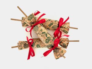 Homemade Christmas crackers are filled with a paper crown, a joke, and a prize. When pulled apart, they make a satisfying "bang."