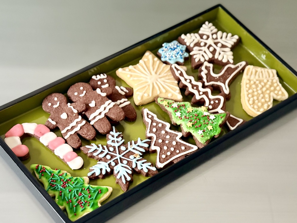 A selection of Christmas cookies made by grandma and granddaugter.