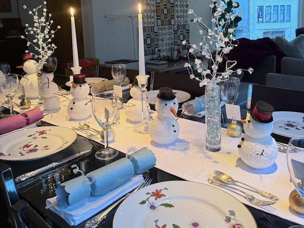 Snowman Christmas centerpiece fashioned from styrofoam balls make a Christmas Eve centerpiece. The snowmen can be made well ahead of the holidays.