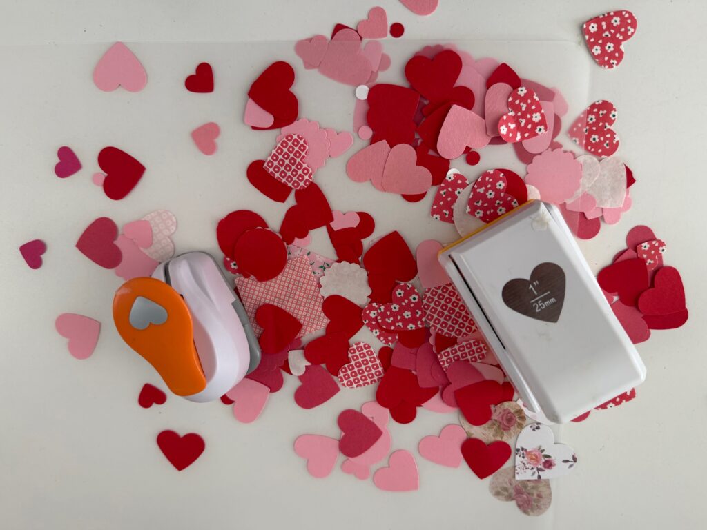 A variety of hearts cut with heart-shaped paper punches are used to make Valentine placemats.