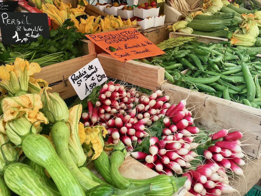 Inspiration for salads: Market in Nice, France is overflowing with squash blossoms, radishes, peas, and more.